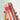 Hand holding a can of Buci Hard Kombucha with red and white striped design.