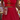 Person wearing a red dress with floral details holding a can of BUCÏ Wild Berries Hard Kombucha.