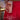 Person in a red dress holding a striped can hard kombucha Buci alcoholic